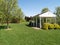 Picnic pavilion by a green lawn and trees