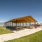 Picnic pavilion and playground with view of lake snow peaked mountain and sky