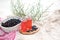 Picnic with red watermelon juice and berries in white basket on sand