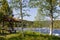 A picnic spot by the Namsen River, Norway, with a mossy-roofed shelter and wooden benches