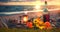 picnic on sunset at sea , straw hat, wine ,juice,and wild flowers on beach sand ,sun blurred light