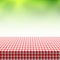 Picnic table covered with checkered tablecloth