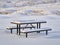 Picnic table covered by fresh snow at Colorado foothills