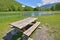 Picnic table in the grass at the edge of a lake in a leisure park