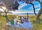 Picnic table served with food and wine at the Pacific ocean beach on Coromandel Peninsula in New Zealand