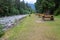 Picnic tables by the river at Kleanza Creek Provincial Park, British Columbia, Canada