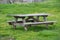Picnic wooden table with benches in picnic and bbq family area in park