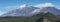 Pico del Teide mountain volcano in snow, bright blue sky.