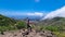 Pico Verde - Woman with backpack enjoying panoramic view on the Teno mountain massif seen from summit Pico Verde, Tenerife.