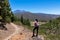 Pico Verde - Woman with backpack on hiking trail from Santiago del Teide to Masca, Teno mountains, Tenerife.