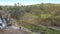 Pictorial landscape with waterfall and girl on rock