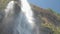 Pictorial large waterfall under clear blue sky slow motion