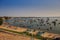 Pictorial Ocean with Fishing Boats near Sand Beach at Sunset