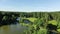 Pictorial park with green trees shadows on deep blue rivers