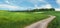 Pictorial rural landscape with winding country lane and little c