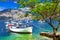 Pictorial scenery with boats in beautiful lake Lago di Garda. It