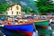 Pictorial scenery with boats in beautiful lake Lago di Garda. To