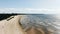 Pictorial sea sand beach against distant city buildings