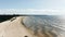 Pictorial sea sand beach against distant city buildings