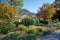 Pictorial spa garden Rottach-Egern with flowers and view to wallberg mountain