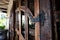 Pictorial style, wooden door with wrought-iron hinges and hook in famous restaurant Bali
