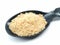 A picture of asafoetida powder on black spoon,