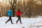 Picture from back of sports man and woman on morning run in winter