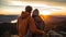 the picture of the back view of a couple of hikers on a mountain peak during golden hour