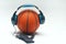 Picture of basketball listing music with headphone and smartphone.