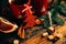 Picture of beautiful Christmas table setting, shining white plate with red cup for coffee decorated holiday dinner, branch of berr