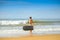 Picture of beautiful girl with bodyboard, ready for fun. Beach background