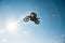 A picture of a biker making a stunt and jumps in the air