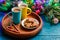 Picture of blue table with Christmas cookies, two mugs with cocoa, caramel sticks, branches of spruce