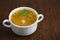 A picture of a bowl of traditional chicken soup served in a bowl over wooden background