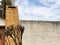 A picture of a brick fireplace chimney that sits on a house with blue sky as background