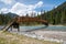 A picture of a bridge crossing a river, with a mountain in the background. Kootenay National Park,