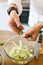 Picture of brunet cooking vegetables on table