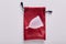 Picture of clean rubber white menstrual cup lying on red cotton little bag, being isolated over white background, alternative