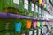 Picture of colored pails hanging on taps of perfume bottles