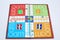 Picture of colorful tokens and dice on the ludo
