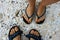 Picture of couples feet in slippers on beach