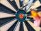 Picture of Darts arrow hitting in the target center of dartboard. concept business goal to marketing success. Business target or