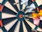 Picture of Darts arrow hitting in the target center of dartboard. concept business goal to marketing success. Business target or