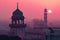 A picture of the dome and a clock tower in a Mosque at sunset or sunrise, the tallest clock tower