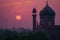 A picture of the dome and a clock tower in a Mosque at sunset or sunrise, the tallest clock tower