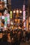 A picture of Dotonbori at night, filled with people and signs advertising shops.