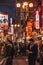 A picture of Dotonbori at night, filled with people and signs advertising shops.