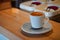 Picture Focus selection: Coffee in a white cup placed on a counter table in a warm atmosphere