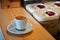 Picture Focus selection: Coffee in a white cup placed on a counter table in a warm atmosphere