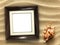 Picture frame on shells and sand background